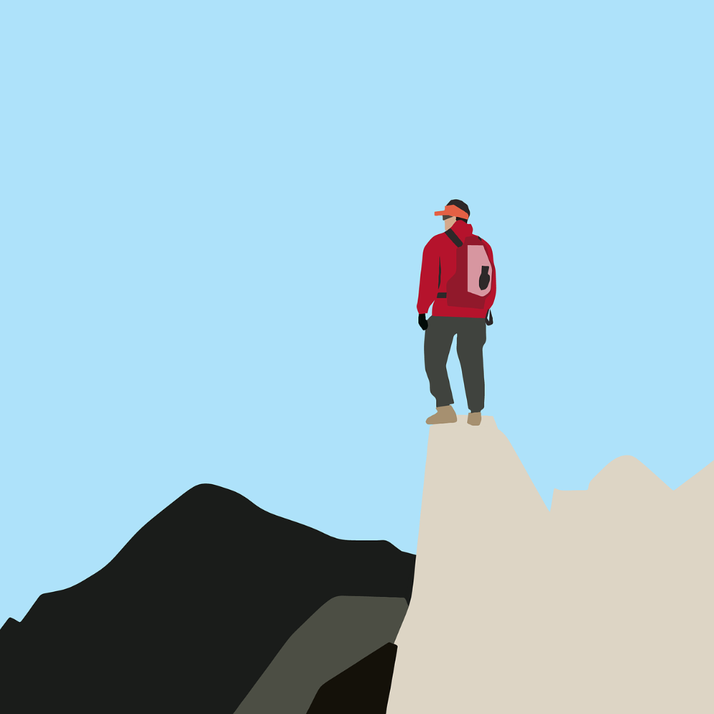 Rysunek: Mężczyzna stojący na szczycie góry